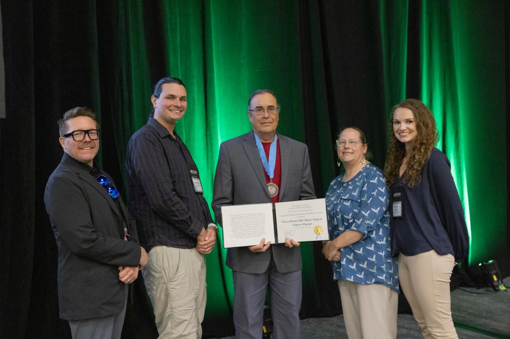 Myaamia community members display the award