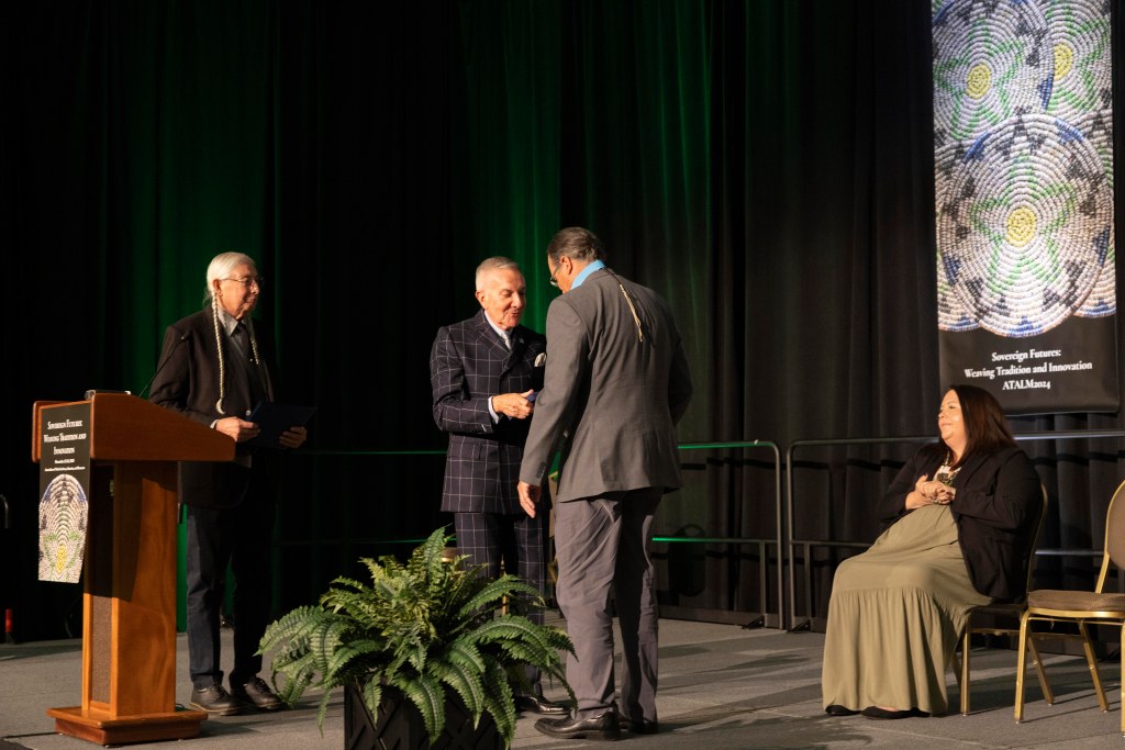 Daryl Baldwin accepts the award from Richard West